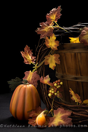 Autumn scene with apple basket, decor pumpkin, and leaves on black background